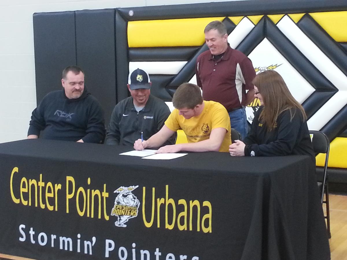 Logan Holtz, a senior at Center Point-Urbana High School, signs his National Letter of Intent to play baseball at MCC in 2014.