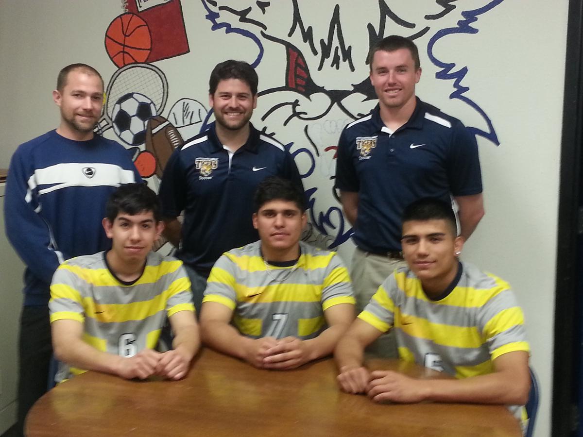 Marshalltown H.S. seniors (L-R) Jose Cordova, Martin Chavarria, and Agustin Ortiz are joined by (L-R) MHS head coach Chris Fuchsen, MCC head coach Rafael Martinez, and MCC assistant coach Creighton Jenness as they commit to play for the Tigers in the fall of 2014