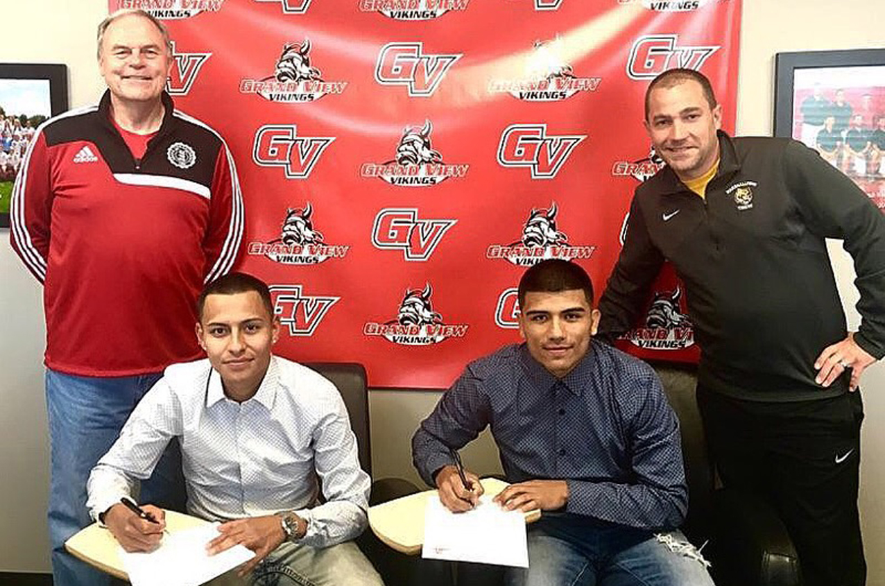 Daivd Gomez (L) and Agustin Ortiz, pictured with Grand View head coach Blair Reid and MCC assistant coach Chris Fuchsen, sign to play soccer at Grand View next season