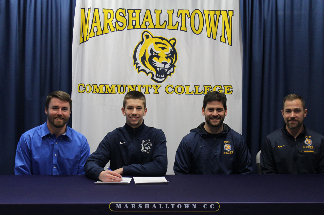 Rafael Pereira, joined by MCC goalkeeper coach Creighton Jenness (L), head coach Rafael Martinez, and assistant coach Chris Fuchsen (R) signed a National Letter of Intent to join Rutgers University