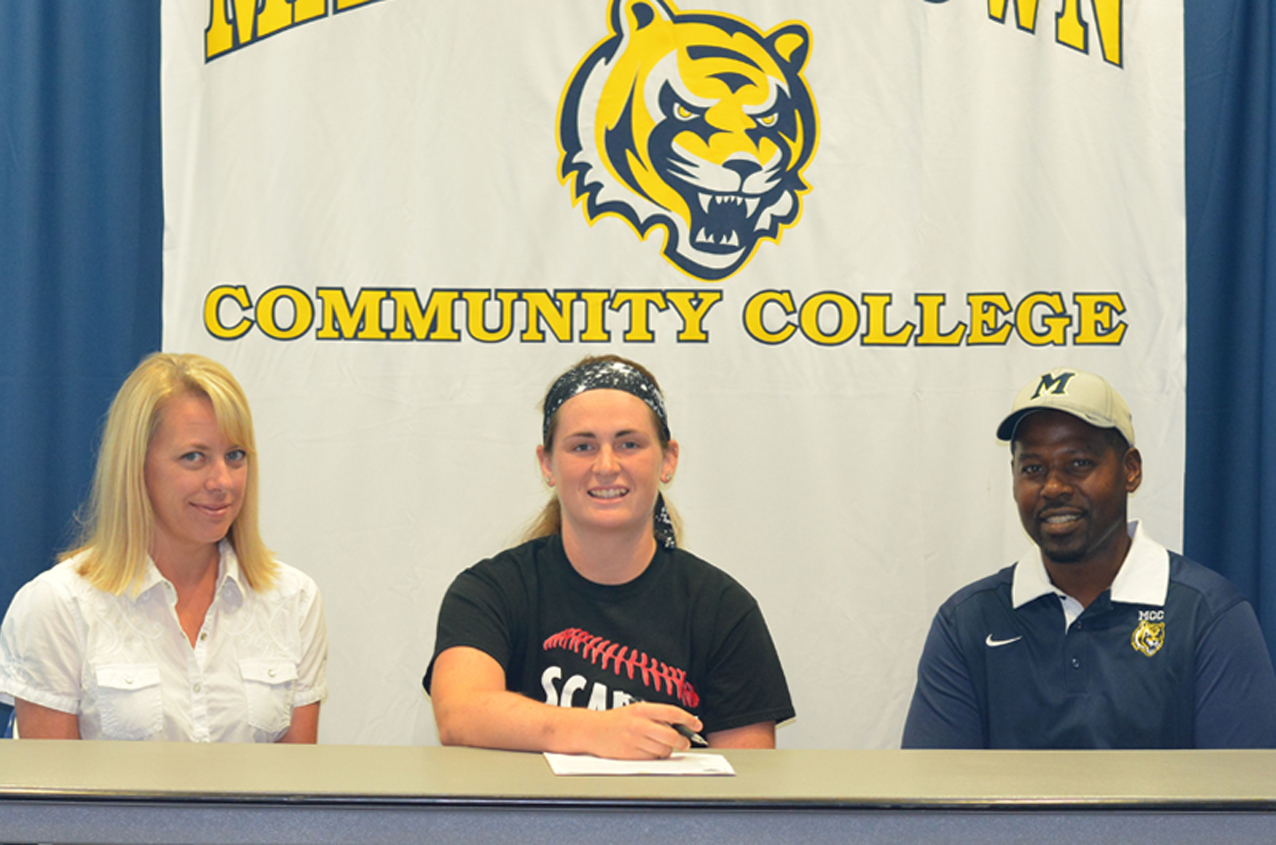 Courtney Fudge, flanked by her mother, Missy, and MCC head coach Garland Shirley, signed a National Letter of Intent to join the Tiger softball program in 2015