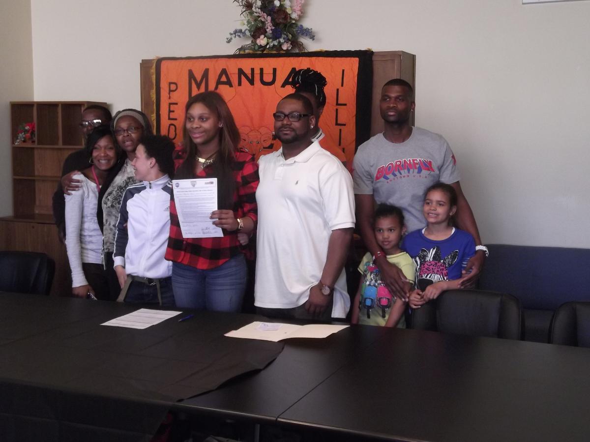 Chassidy Lewis is joined by family members as the Manual High School senior signed her National Letter of Intent on Friday