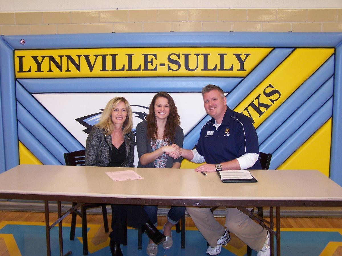 Cassie Cullen joins her mother, Monica, and MCC head coach Chris Brees at Wednesday's signing. Cullen inked her letter of intent to play for the Tigers in 2014.