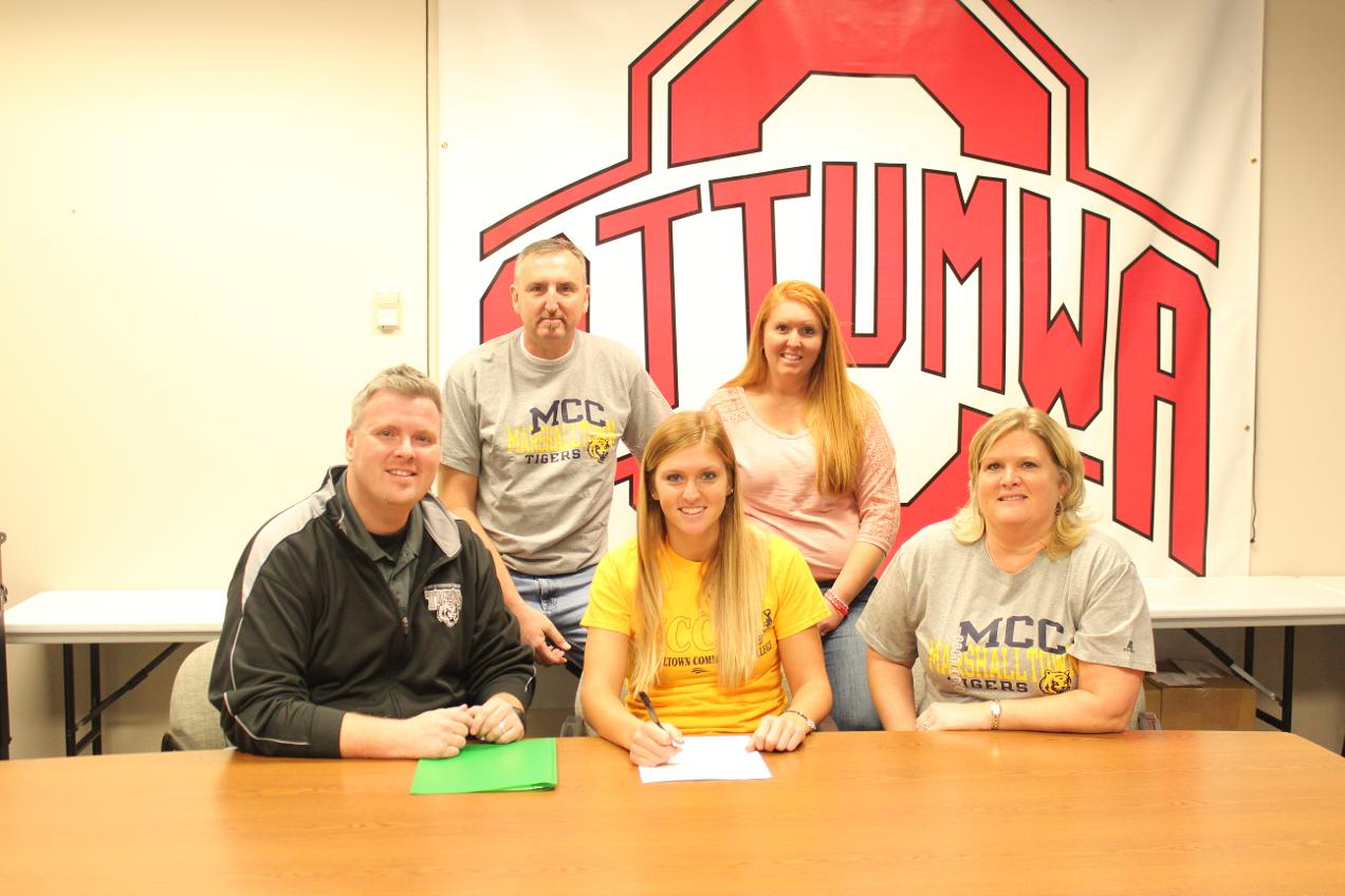 Karissa Wilcoxson (center) is joined by MCC head coach Chris Brees (left), parents, and sister.