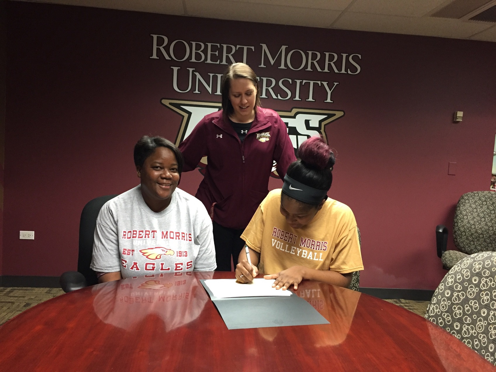 DaNesha Cowley, joined by her mother and Robert Morris head coach Jess Gregory signs a National Letter of Intent to join the Eagles next season